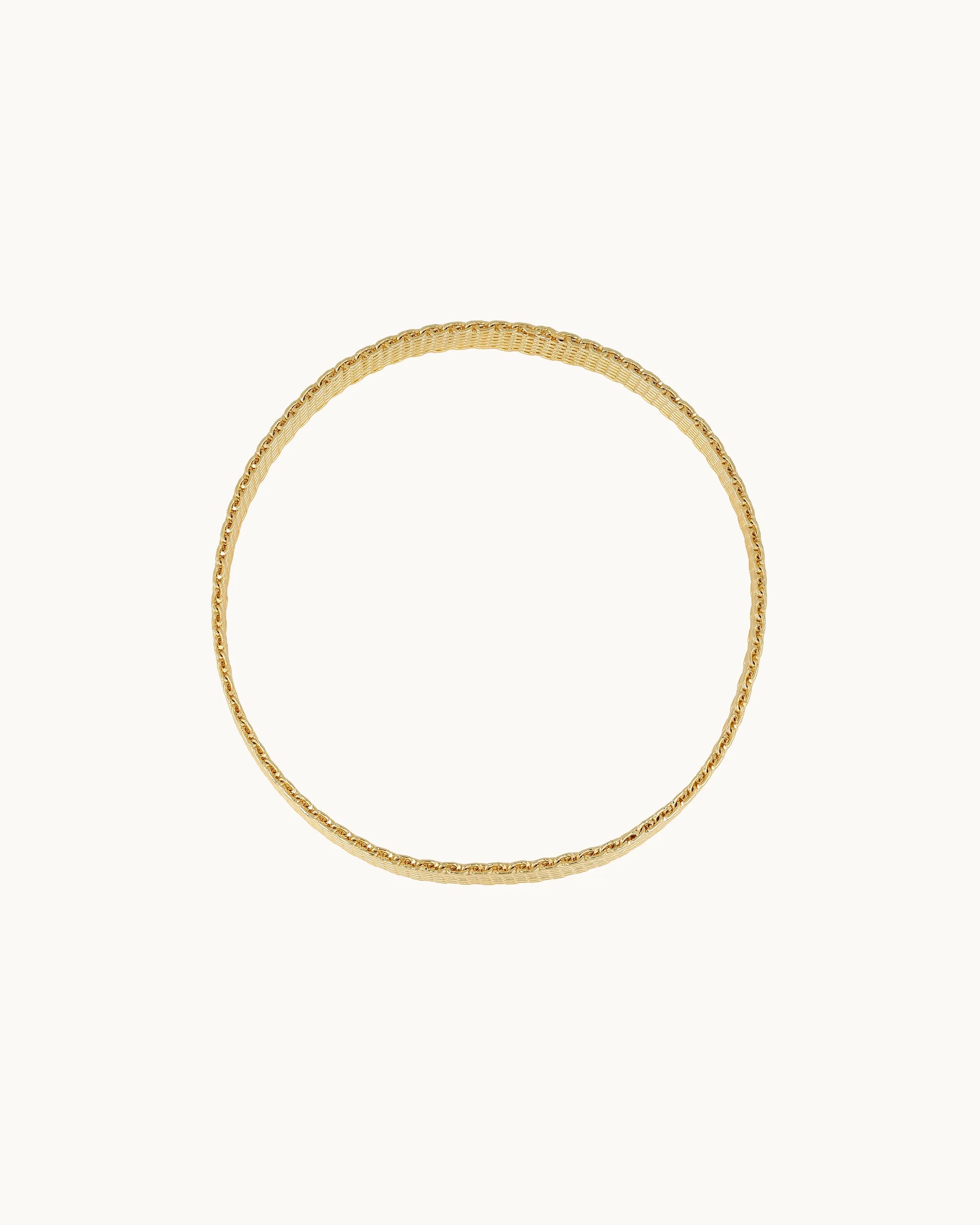 Sleek wide flat mesh weave statement bangle worn at wrist or upper arm in gold, by Kaleido Jewellery Singapore.