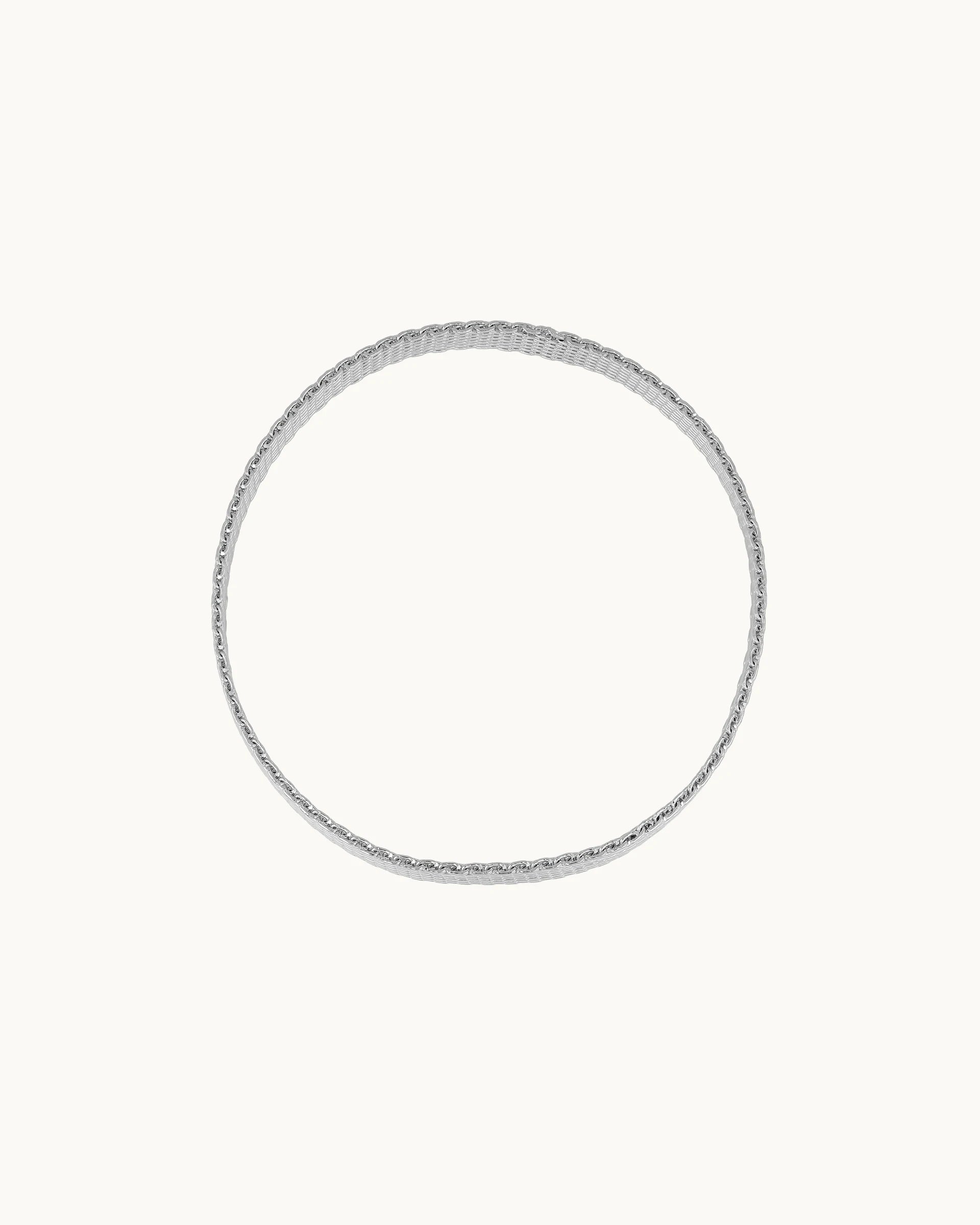 Sleek wide flat mesh weave statement bangle worn at wrist or upper arm in silver, by Kaleido Jewellery Singapore.