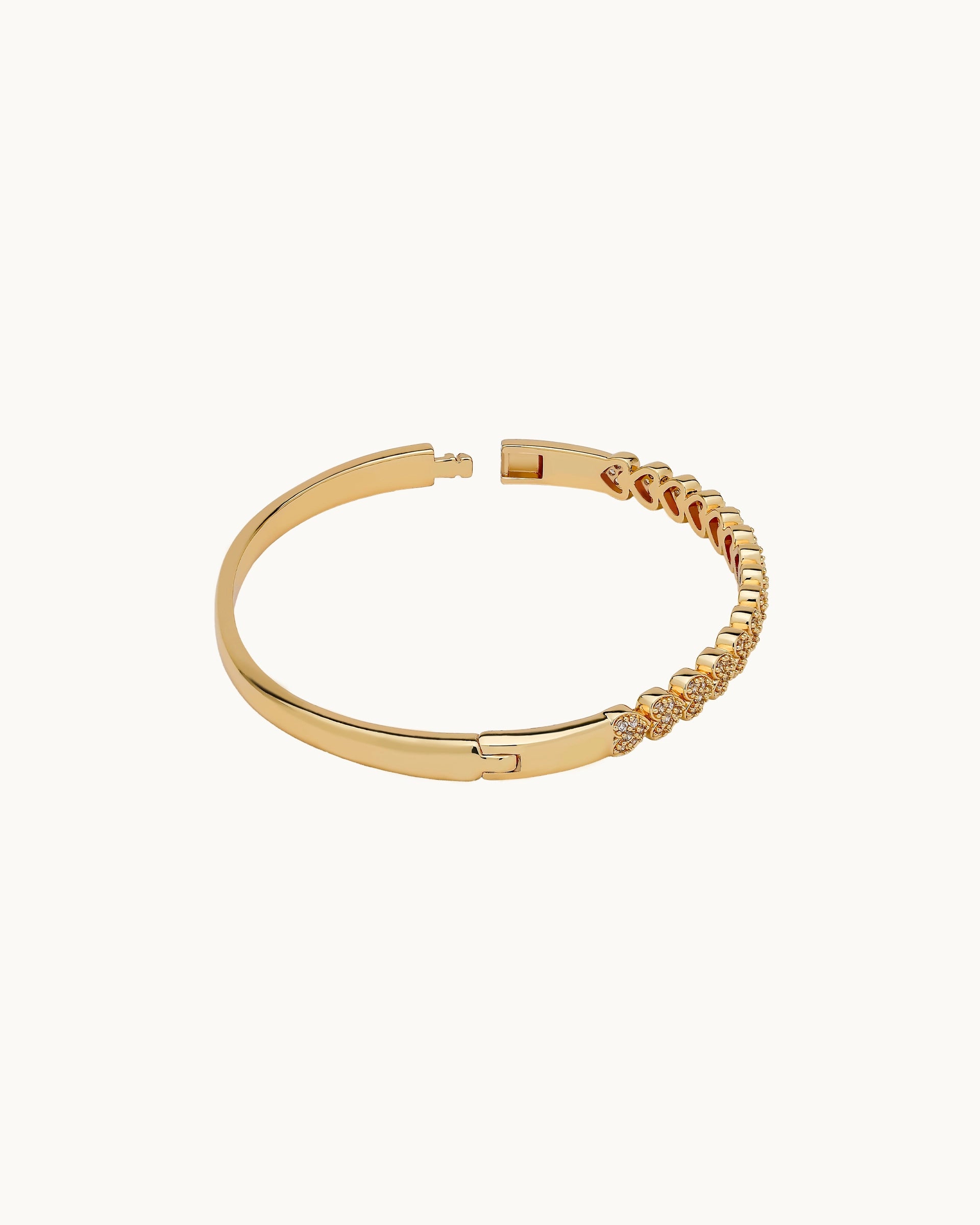 Pavé cubic zirconia heart motif hinged bangle in silver, by Kaleido Jewellery Singapore.
Pavé cubic zirconia heart motif hinged bangle in gold, by Kaleido Jewellery Singapore.