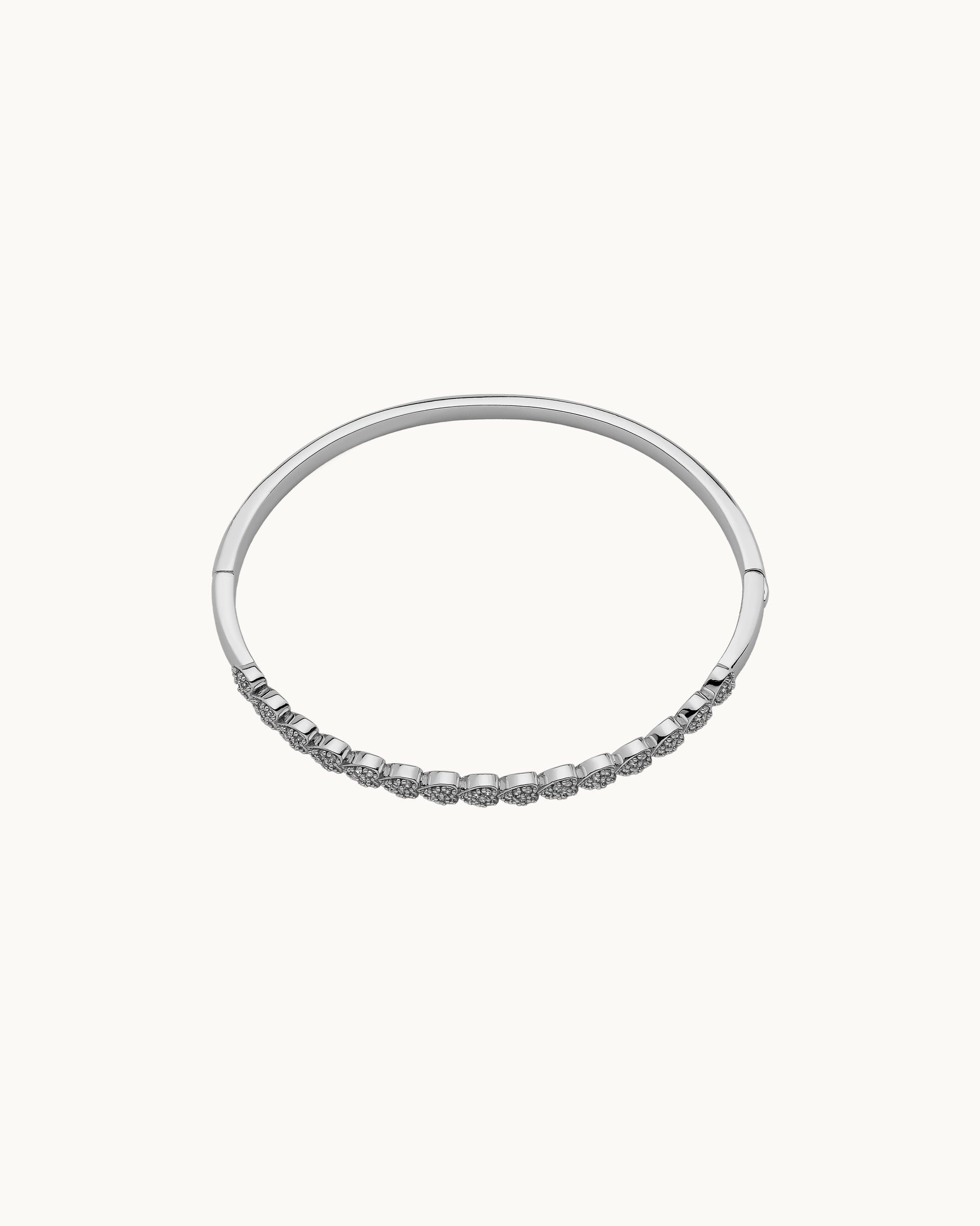 Pavé cubic zirconia heart motif hinged bangle in silver, by Kaleido Jewellery Singapore.
Pavé cubic zirconia heart motif hinged bangle in gold, by Kaleido Jewellery Singapore.