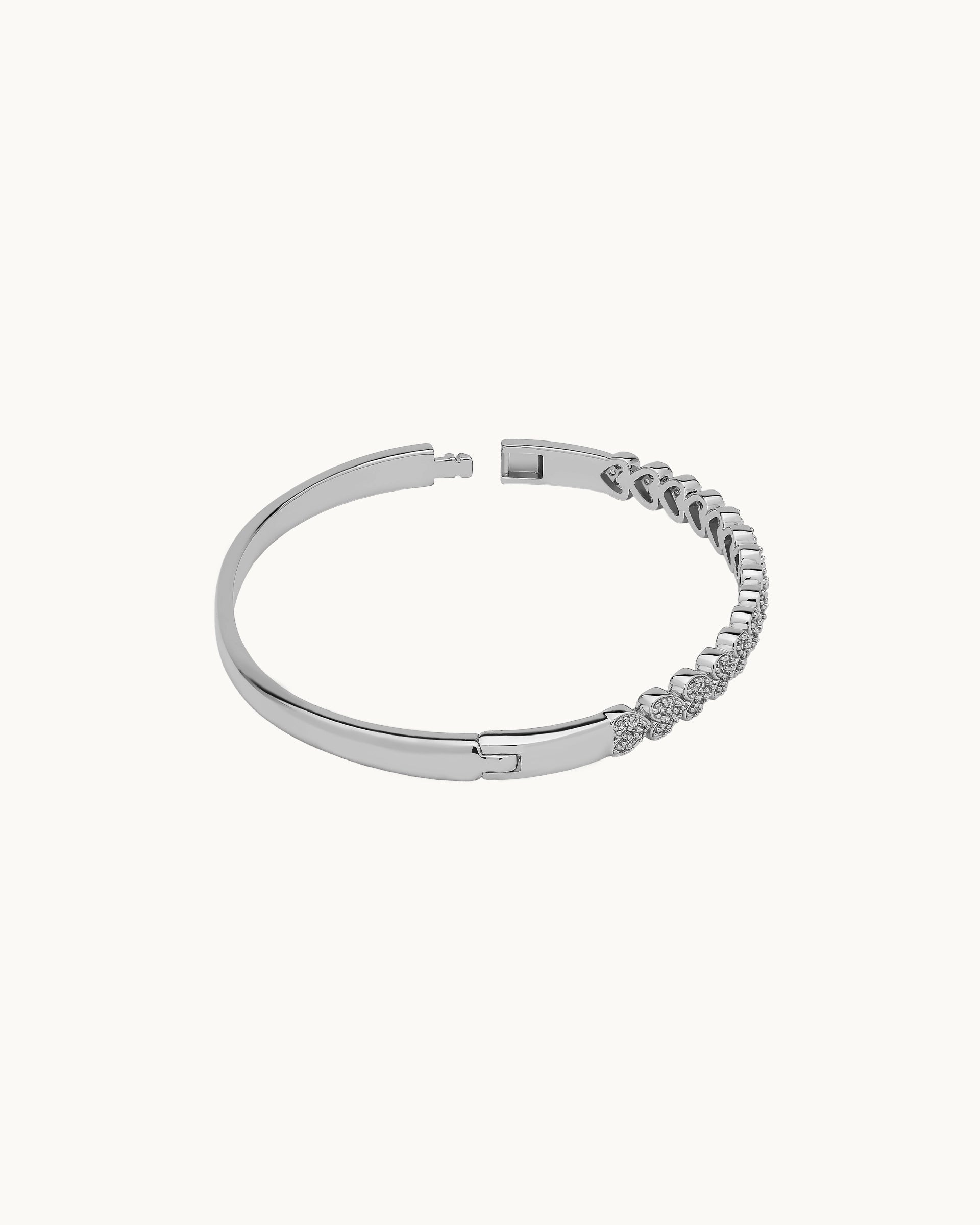 Pavé cubic zirconia heart motif hinged bangle in silver, by Kaleido Jewellery Singapore.
Pavé cubic zirconia heart motif hinged bangle in gold, by Kaleido Jewellery Singapore.