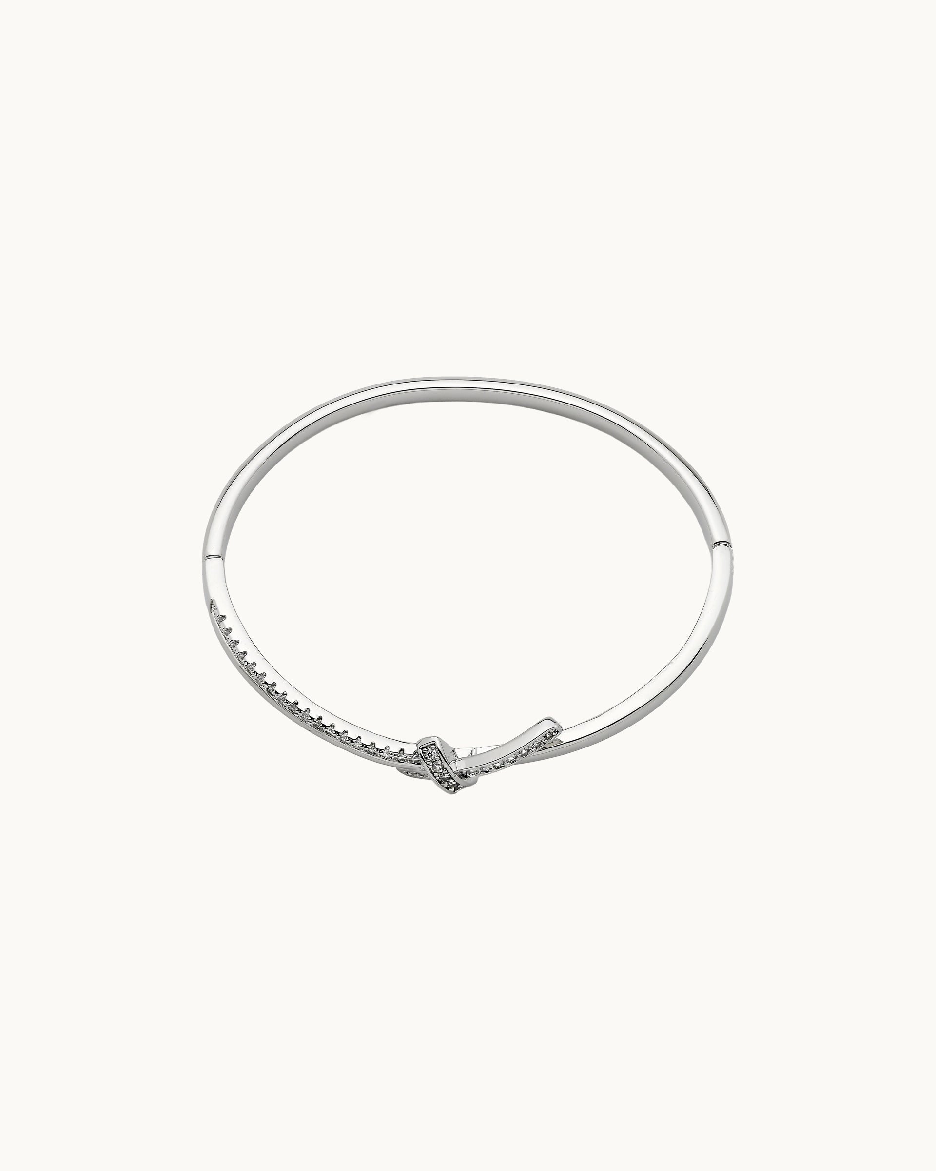 Polished hinged bangle with pavé cubic zirconia knot detail in silver, by Kaleido Jewellery Singapore.
Polished hinged bangle with pavé cubic zirconia knot detail in gold, by Kaleido Jewellery Singapore.