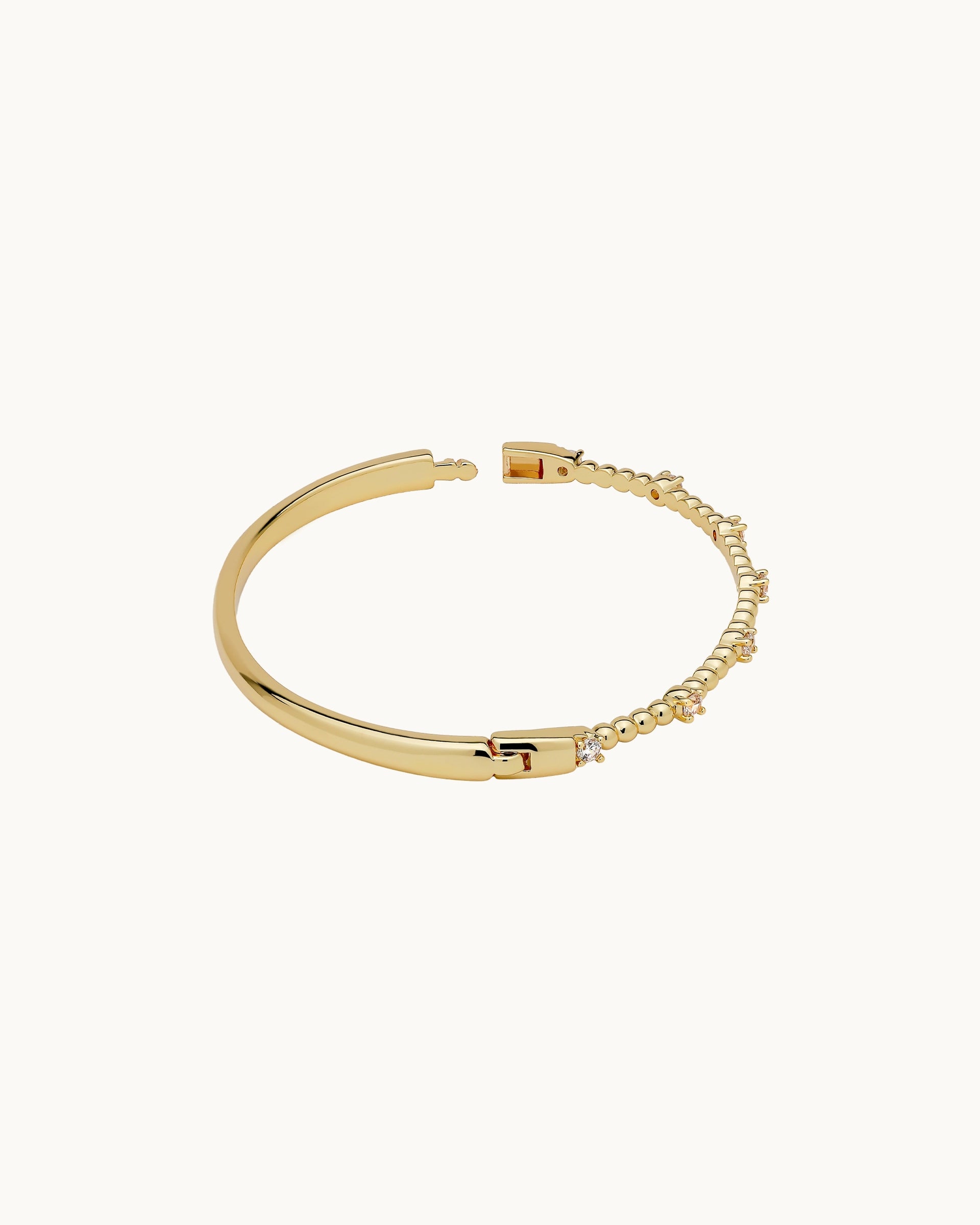 Polished spherical bead and round cubic zirconia solitaire hinged bangle in silver, by Kaleido Jewellery Singapore.
Polished spherical bead and round cubic zirconia solitaire hinged bangle in gold, by Kaleido Jewellery Singapore.