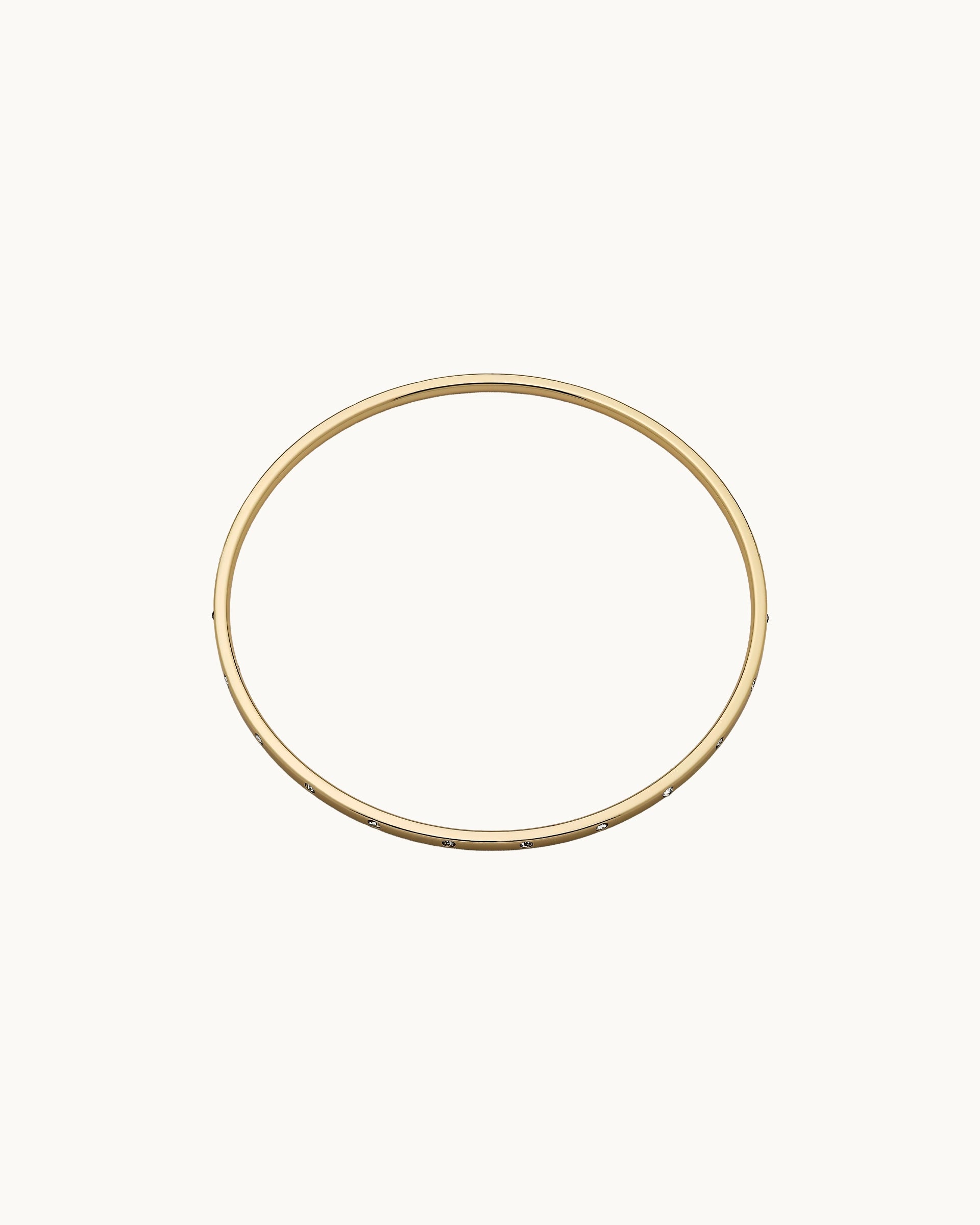 Slim polished bangle with evenly spaced flush-set crystals in gold, by Kaleido Jewellery Singapore.