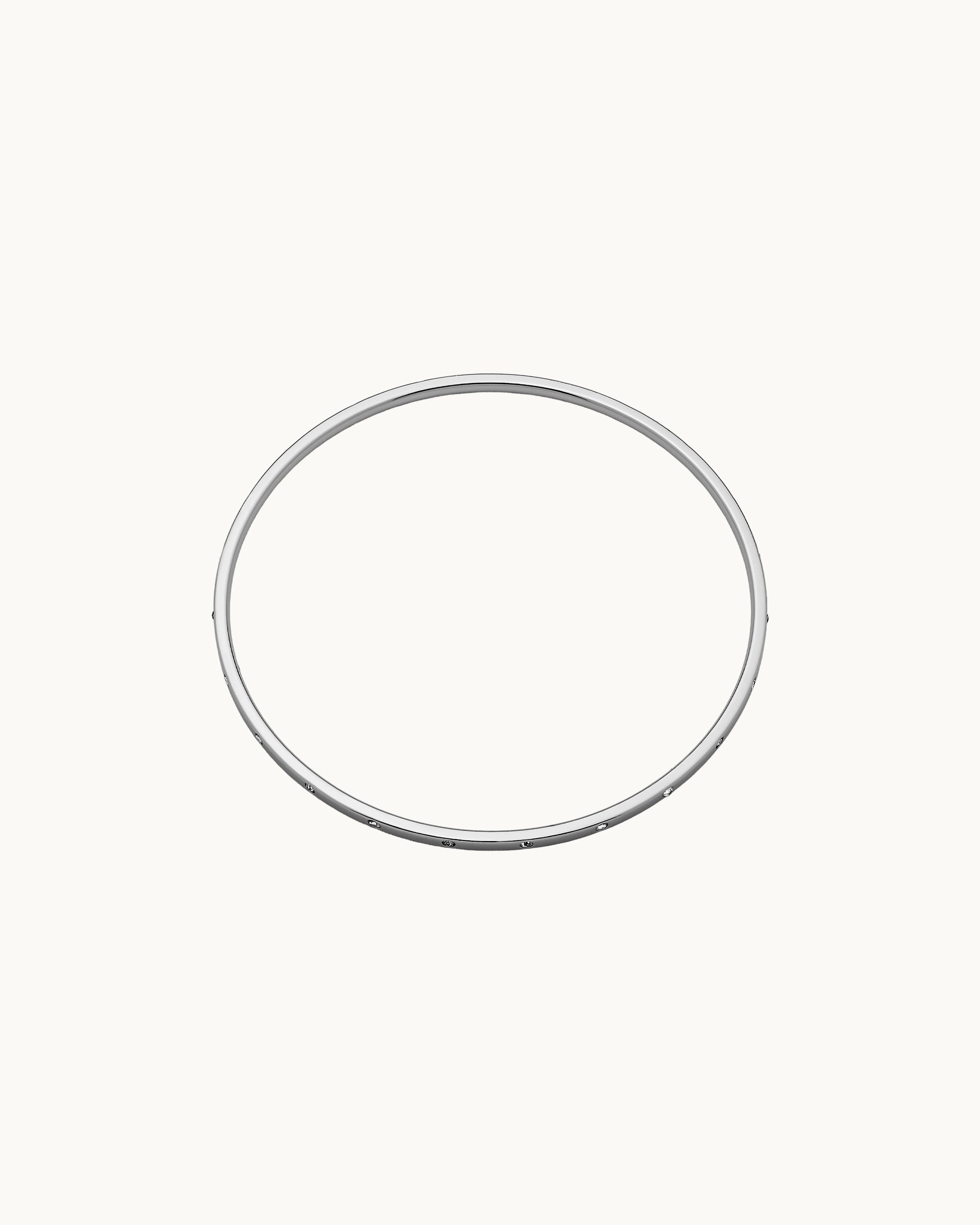 Slim polished bangle with evenly spaced flush-set crystals in silver, by Kaleido Jewellery Singapore.